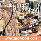A photo of a mannequin with a summer dress and hat is in front of a display of multiple types of sandals in a women's boutique. Text reads "Slide into Summer" in white. A peach bottom border reads "www.Shop60048.com" in bold white font.