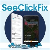 A light blue background has a navy blue circle in the center. Atop the circle is a smart phone with the Libertyville logo and a program menu. Text reads "SeeClickFix."