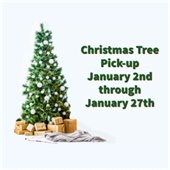The background is light blue. In the left center is a decorated Christmas tree with presents wrapped in brown paper. Green text to the right reads "Christmas Tree Pick-Up January 2nd through January 27th.”