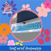 A light blue background with multicolored cherry blossom flowers has a circular photo in the middle. The sign in the photo says "847 Running Company." The border at the bottom says "Featured Business."