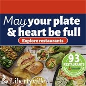 A red border is at the top with a blue border beneath that says "May your plate and heart be full." Below is a photo of a table spread with sandwiches and wraps.