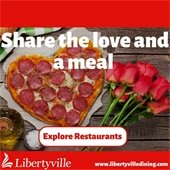 A heart-shaped pepperoni pizza is on a wooden table next to a handful of roses. Text reads "Share the love and a meal - www.LibertyvilleDining.com."