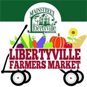 A cartoon of fruits and veggies in a buggy reads "Libertyville Farmers' Market."