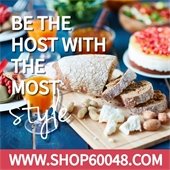 The background is a table with accoutrements, including a sliced bread loaf and small wine glass with an orange beverage. Text reads "Be the host with the most style - www.Shop60048.com."