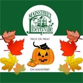 The background is dark green. In a white box in the center are fall leaves and a pumpkin with a black cat in it. Text reads "MainStreet Libertyville Illinois, Trick or Treat on MainStreet."