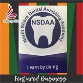 The background is stripes in red, orange, black, and green. In the center is a purple and white logo with a tooth in the center that reads "North Shore Dental Assisting Academy - Learn by Doing." Beneath it reads "Featured Business."